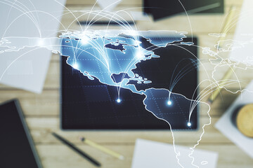 Double exposure of abstract digital world map with connections and modern digital tablet on background, big data and blockchain concept