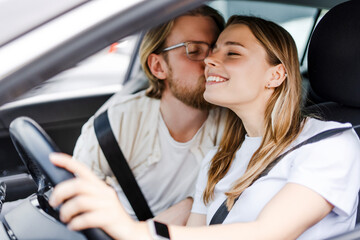 Man and woman kissing in a car