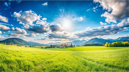 Obraz premium Panoramic natural landscape with green grass field, blue sky with clouds and and mountains in background. Panorama summer spring meadow. Shallow depth of field
