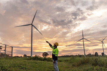 Professional Man Maintenance engineers working in wind turbine farm at sunset.  Engineer Man...