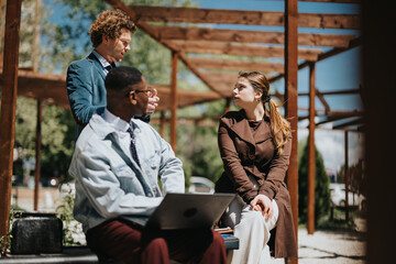 Cheerful executives engage in a brainstorming session outside, sharing innovative ideas for their startup in a city environment.