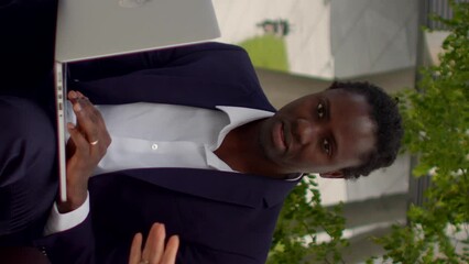 Vertical portrait business man and woman talking. Using laptop with artificial intelligence, businesspeople engages in remote work, handling tasks and responsibilities from location with internet. 