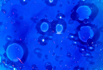 Blue background. An abstraction. Oil circles on the water