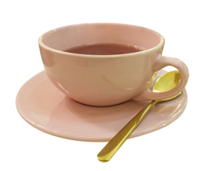 Pink cup of tea with gold teaspoon isolated on white background.
