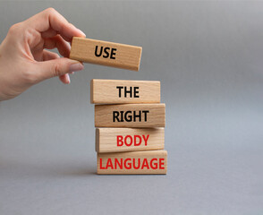 Use the right Body Language symbol. Concept words Use the right Body Language on wooden blocks. Businessman hand. Beautiful grey background. Business concept. Copy space