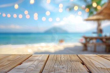 Fototapeta premium Wooden table with blurred background of beach bar and sea view at summer time for product display montage, vacation concept, banner design.