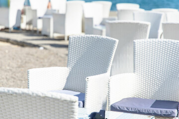Obraz premium White Wicker Chairs on a Beachside Patio in town Opatija