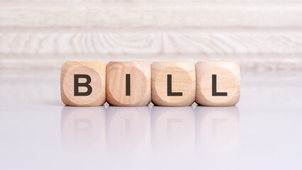 the word bill is written on a wooden blocks structure. Blocks on a bright gray background. selective focus