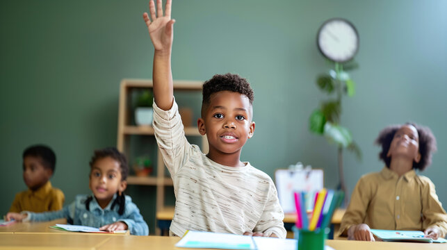 little black boy child raising hand at school class