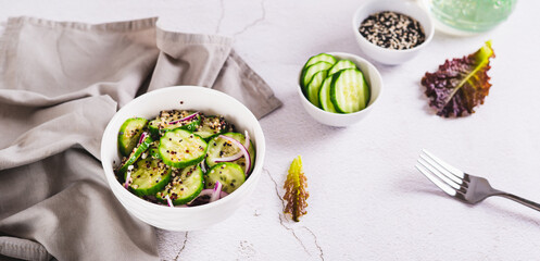 Vegetarian salad of quinoa, cucumber and red onion in a bowl on the table web banner