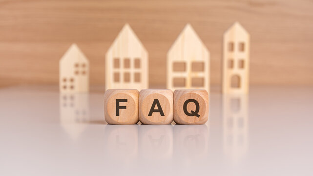 Cubes with message FAQ surrounded by wood home. Quesiton and answer about housing problems