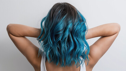 Obraz premium rear view of woman with wavy ombre blue dyed hair, white background