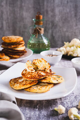 Spicy vegetarian cauliflower fritters on a plate on the table vertical view