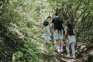 Group of friends hiking together on a scenic mountain trail, enjoying nature and outdoor adventure on a sunny day.