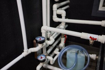 Modern plumbing system with gauges and water pipes for measuring pressure and connections