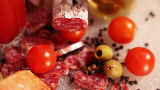 Fresh ciabatta, delicious Spanish fuet cut into pieces, tomato juice in a glass and olives. Siesta, Spanish tapas