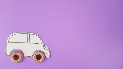 Car cookies. car with wheels made of cookies rides on a purple background. Template with space to insert text, design, advertising for food delivery business, car repair services, auto parts store.