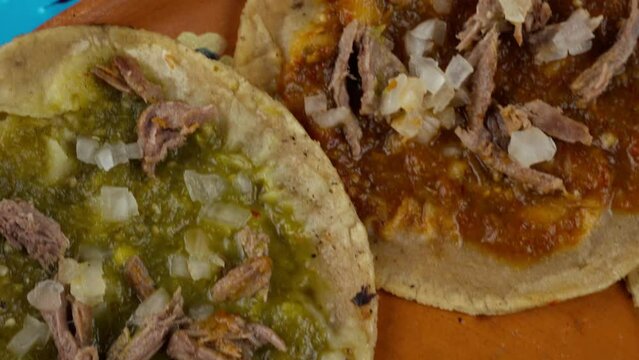 Mexican Chalupas with Shredded beef and onion, Mexican flag, Dolly in closeup