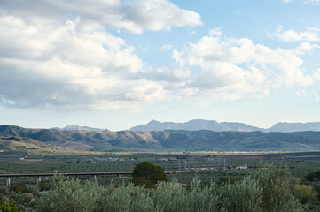 Scenic landscape of rolling mountains under a cloudy sky
