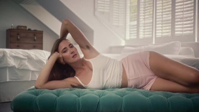 Sexy woman lying on the bed and showing her armpit hair