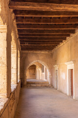 Europe, Greece, Crete, Rethymno. Venetian Baroque, 16th C. Eastern Orthodox Monastery.  The Holy Monastery of Arkadi. Arched stone passageway.