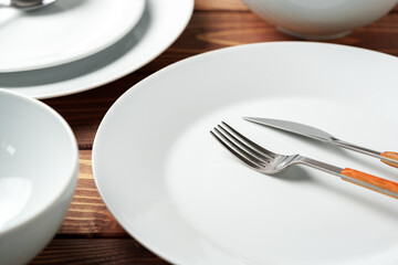 White ceramic tableware on wooden background top view