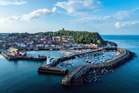 Scarborough Lighthouse and Harbour from a drone, Vincent Pier, Scarborough, North Yorkshire, England, Europe
