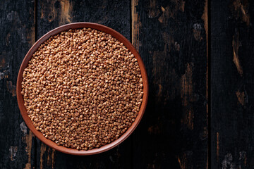 Raw Buckwheat Grains on Clay Plate, Copy Space