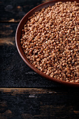 Raw Buckwheat Grains on Clay Plate, Copy Space