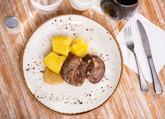 Spanish dish Carrilleras de cerdo al horno, grilled meat with potatoes