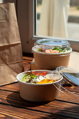 Take out poke bowl on wooden background