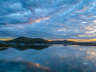 Sunrise over the bay water with clouds and reflections