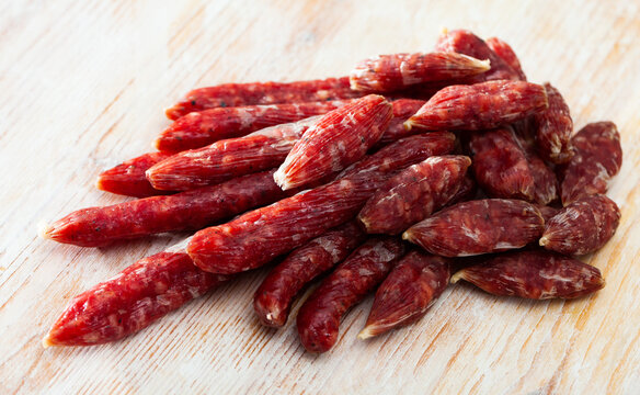 Spicy Spanish Secallona sausages on wooden surface