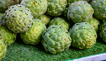 Fresh ripe green organic artichokes heads on local farmers market in Dordogne, France