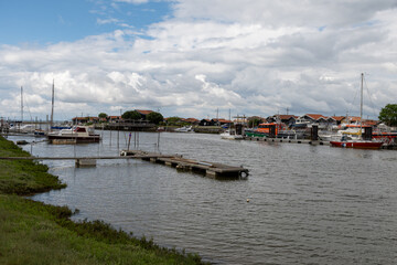 Fototapeta premium Travelling in France, old wooden huts and oysters farms in Gujan-Mestras village, cultivation and sale of fresh oysters seashells, Arcachon bay, Atlantic ocean, France, tourists destination