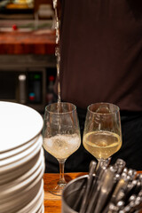 Pouring of txakoli or chacolí slightly sparkling very dry white wine produced in Spanish Basque Country in typical pinchos bar in old part of San Sebastian or Donostia, Spain