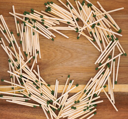 This is a picture of a pile of matches, moved to form an interesting pattern with a wooden background.