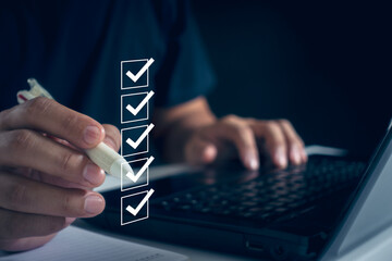 Business performance checklist concept. Business people use laptops to take online checklist...