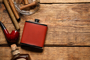 New hip flask and cigars on wooden background