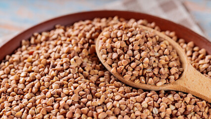 Raw Buckwheat Grains in Clay Bowl, Close Up
