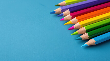 Naklejka premium A row of colorful pencils on a blue background