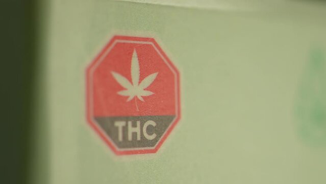 Macro close up of THC warning on the CBD box. CBD or cannabidiol made of Marijuana weed plant and have analgesic pain-relieving properties. CBD may provide relief for various types of pain.