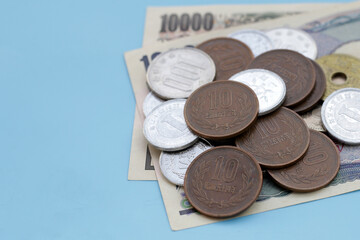 Japan money, Yen banknotes with coins on blue background.