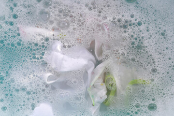 White cloth soaked in powder detergent water dissolution, washing cloth. Laundry concept