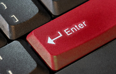Large bright red colored enter key on a computer keyboard, confirmation call to action abstract concept, object closeup macro detail, nobody. Accepting, confirming an action, buying, sending messages