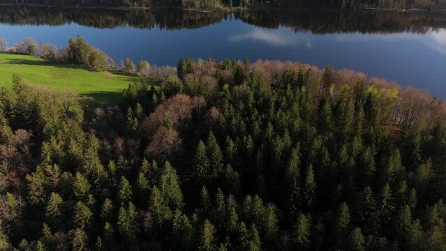Aerial view, Staffelsee with islands, Garmisch Partenkirchen region, Bavaria, Germany near Murnau in sunny weather at sunset in spring. Drone view over islands of a large beautiful lake in Bayern. 