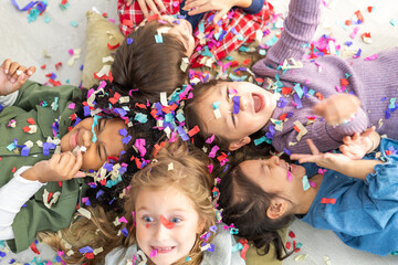 Portrait happy friend school girl children student, kid, child having fun activity play party, festive and event celebration with colorful confetti, birthday, new year, children day at school