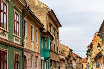 Fototapeta premium Europe, Romania Brasov. 16th C arcaded, and terra cotta roofed houses and narrow streets.