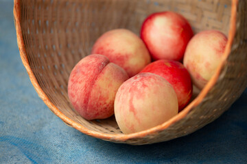 close up peaches in basket