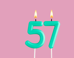 Green candle number 57 - Birthday card on pastel pink background